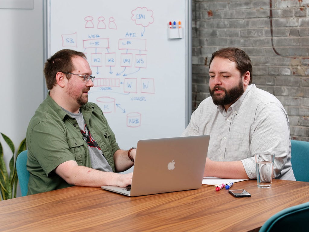 Al and David collaborate on a custom software build.