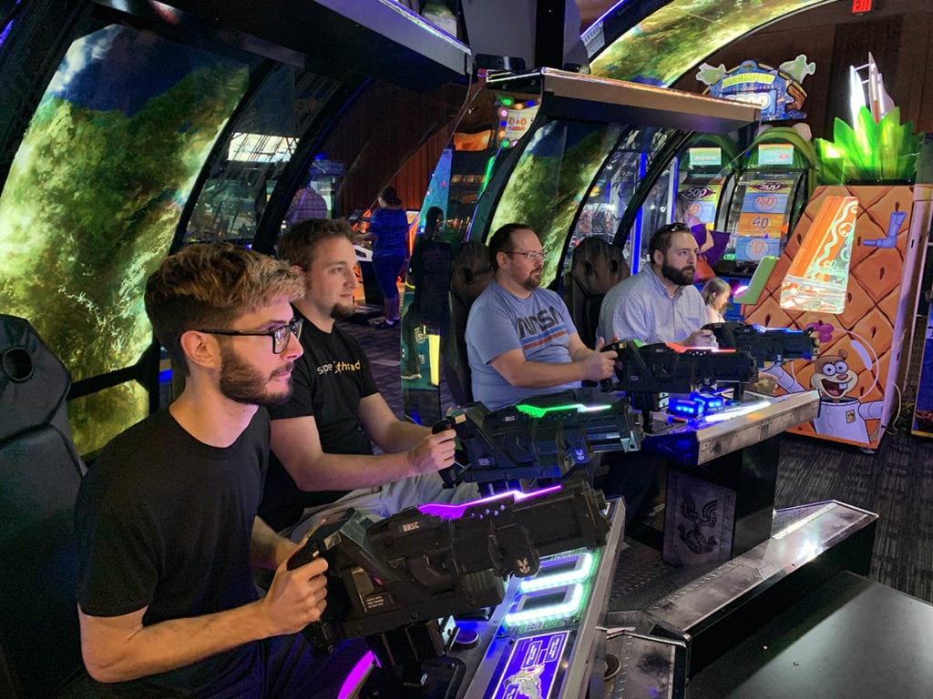 A few of the team playing at the arcade.