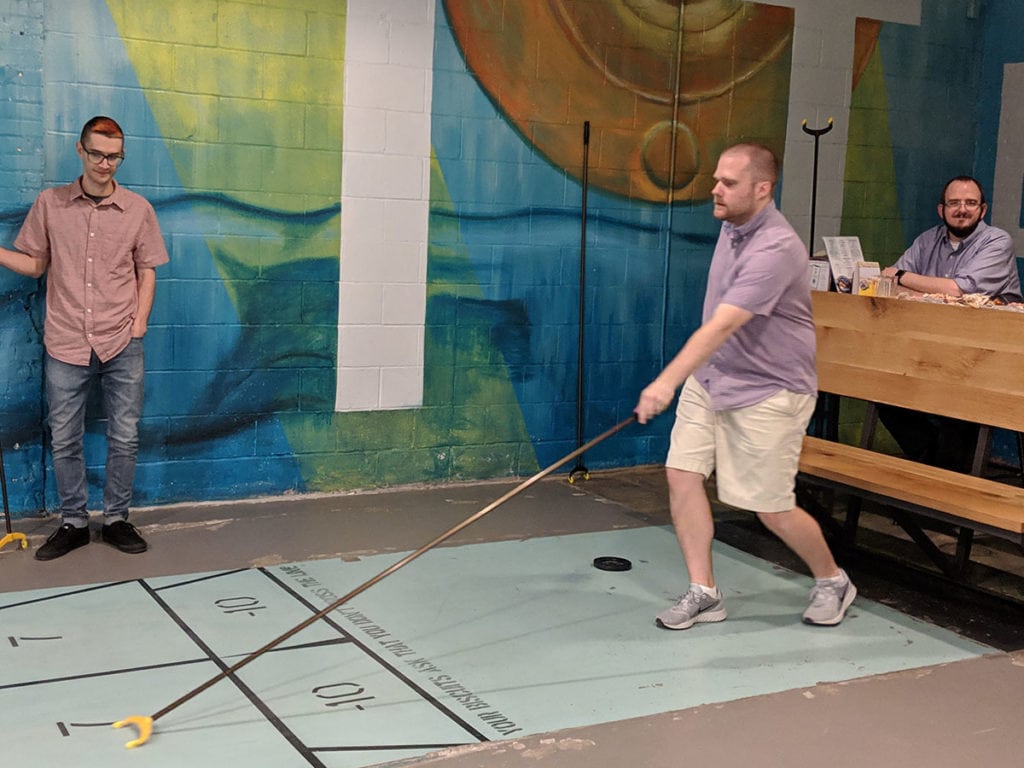 A few of the team playing shuffleboard.