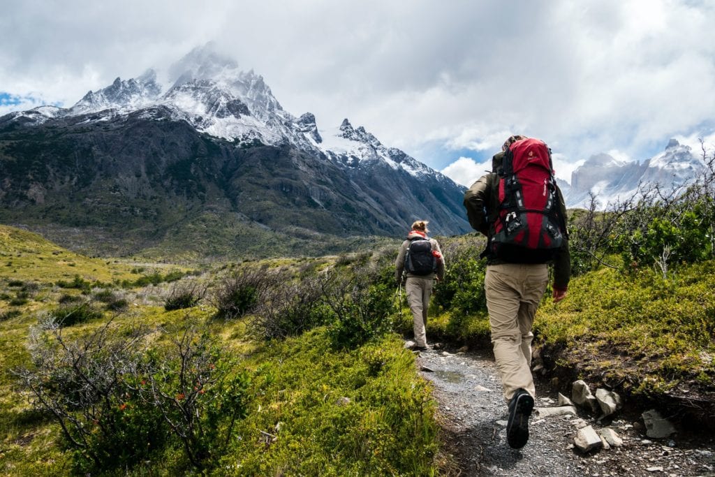 Hikers ascending mountain on trail